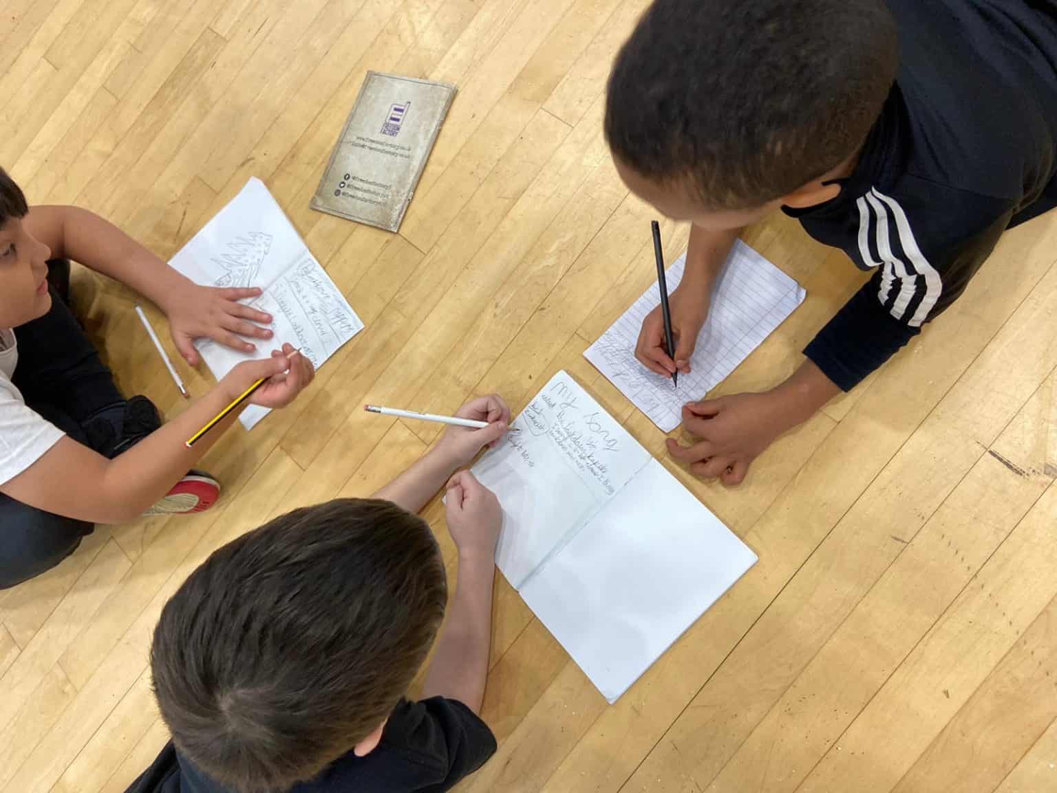 a group of children completing an activity at a programme