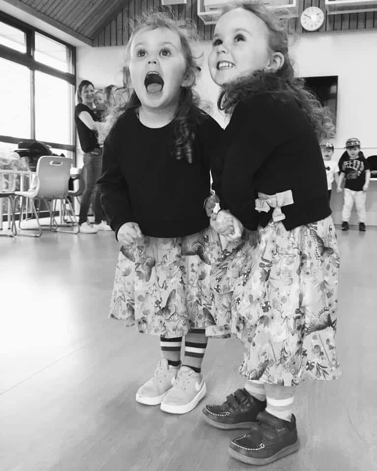 2 girls standing and having fun at a programme session